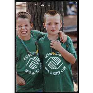 Two boys wearing "Charlestown Boys & Girls Club" t-shirts and posing with their arms around each other during an outing