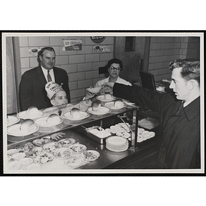 A member of the Tom Pappas Chefs' Club serves a diner as staff looks on at the Hanscom Field Air Force Base restaurant