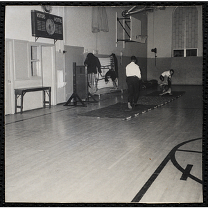 Police officers conduct a K-9 demonstration in a gymnasium
