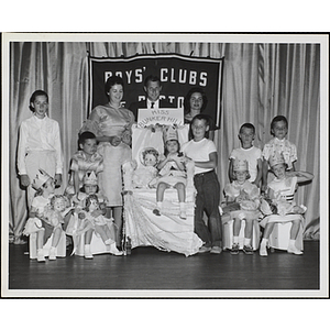 Group portrait of the Little Sister Contest winners with their brothers and three judges, including Richard Harte, Jr., at center