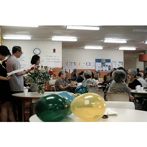 Woman addresses a crowd during a Chinese Resident Association celebration