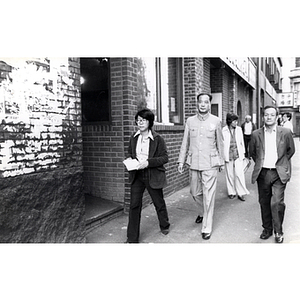 Suzanne Lee and Mr. Wong walking in Chinatown with members of CPA and Youxie delegation