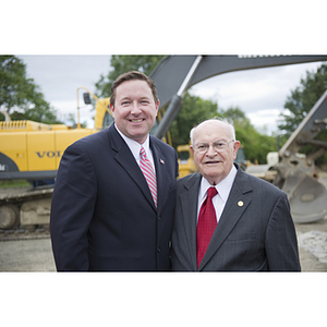 Dr. George J. Kostas stands with a man at the groundbreaking site for the George J. Kostas Research Institute for Homeland Security, located on the Burlington campus of Northeastern University