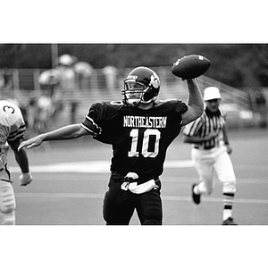 Quarterback Ralph Barone, Class of 1994, passing football during a game between Northeastern and the Connecticut Huskies