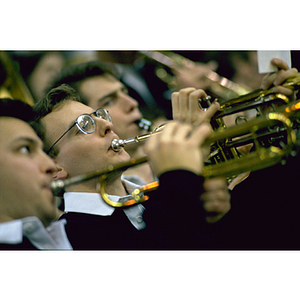 Three men playing trumpets in an orchestra - Digital Commonwealth