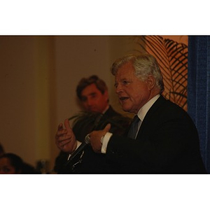 U.S. Senator Edward Kennedy (D-MA) at the podium during a press conference on student aid with Northeastern President Freeland in the background