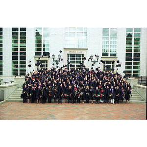 School of Law graduates tossing their hats in the air in front of Dodge Hall