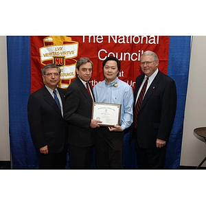 New inductee Victor Tong with his certificate and three others at The National Council Dinner