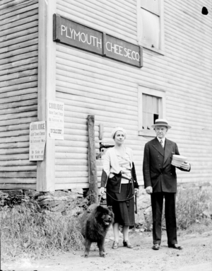 President and Mrs. Coolidge and their dog Blackberry in front of the general store, Plymouth, Vermont, 1931