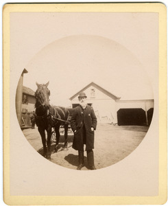Albert Henry Blanchard standing by horse and carriage