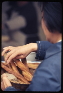 Woman and fried bread sticks