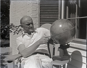 Richard Hallet: Hallet pointing to a spot on a globe