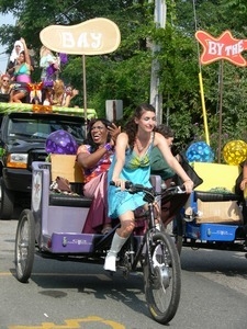 Parade marcher rolling in a pedicab : Provincetown Carnival parade