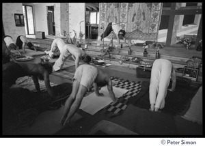 Krishna Das leading yoga stretching exercises in the hall, Rowe Center spiritual retreat