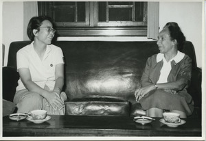 Shirley Graham Du Bois sitting on a couch with an unidentified woman