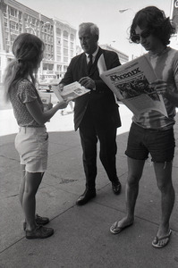 Boston Phoenix promotional photos: Phoenix hawker handing paper to man, Stephen Davis (r) reading