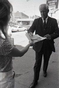 Boston Phoenix promotional photos: Phoenix hawker handing paper to man