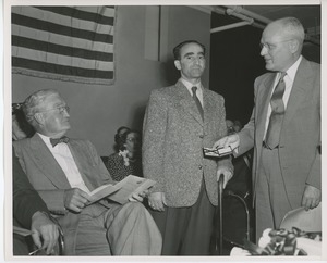 Bruce Barton seated at graduation exercises