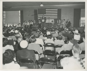 Unidentified special guest speaking on stage at Institute Day