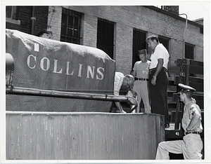 Four unidentified men moving medical equipment