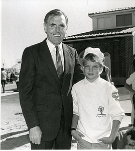 Mayor Raymond L. Flynn standing with an unidentified child near waterfront