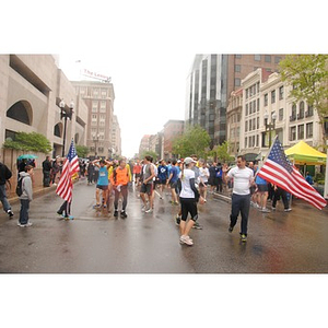 Mick Ross (Holding American Flag) Greets Runners after #OneRun in front of the Boston Public Library