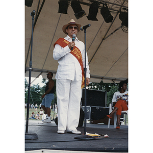 The Grand Marshal of the Festival Puertorriqueño speaks into a microphone