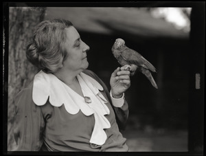 Tryphena M. Clark with pet bird Lori-Bird on her finger