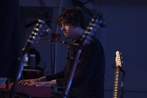 Matt Nakoa (keyboards) performing in concert at the Payomet Performing Arts Center, framed by Tom Rush's guitars