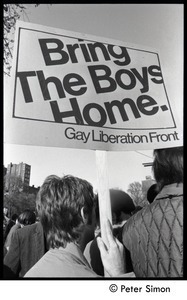 View of a man holding a sign reading 'Bring the boys home -- Gay Liberation Front'