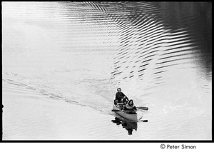 Unidentified man, Ray Mungo, and Verandah Porche in a canoe