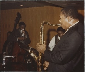 John Coltrane (soprano saxophone) with Jimmy Garrison (double bass) and Elvin Jones (drums) on stage at the Jazz Workshop