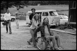 Janice Frey pushing Peter Natti in a wheelchair, Tony Mathews behind, Montague Farm Commune
