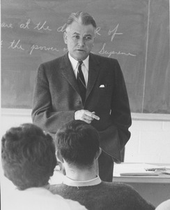 Bert T. Combs standing in class room, speaking to a class
