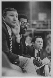 Ray Wilson, unidentified person (possibly Assistant Coach,) and Jack Leaman watch Minutemen basketball game in Curry-Hicks Building