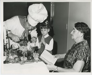 Chef carving turkey for young client in prayer