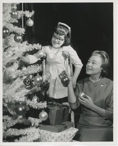 Mrs. Kilbourne and Yvonne Crespo decorating Christmas tree