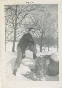 David Kahn posing with one foot up on a rock in the snow
