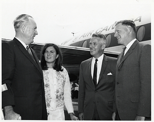 Mayor John F. Collins and daughter Patricia Collins in front of airplane in Saint John, New Brunswick, Canada, with unidentified man and Saint John Mayor Dr. Stephen H. Weyman