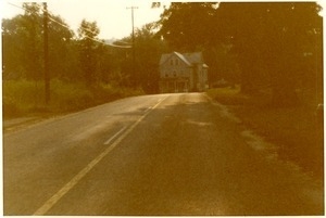 View up a country road of an old house (possiblyt near a Brotherhood of the Spirit house)