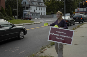 Protest against a pornographic video store in Northampton: protester handing out fliers to cars on North Street