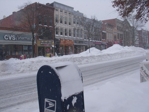 View looking west of deep snow piles in the middle of Main Street, Northampton, Mass.