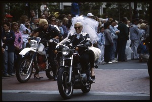 Two motocylcists, one wearing a wedding dress and bridal veil, in the San Francisco Pride Parade