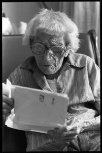 Victoria Moore, 103 years old, reading a letter
