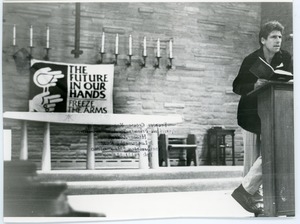 Henry Lyman: full length portrait speaking at the podium at the Edwards Church during a Nuclear Freeze rally