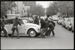 May Day concert and demonstrations: protesters moving Volkswagen Beetle into road