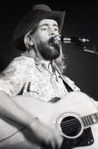 New Riders of the Purple Sage opening for the Grateful Dead at Sargent Gym, Boston University: John 'Marmaduke' Dawson playing acoustic guitar and singing