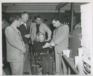 Woman in wheelchair gets water