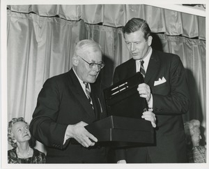 John Lindsay examining box with other man