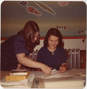 Maria de Lourdes Serpa, smiling, at desk